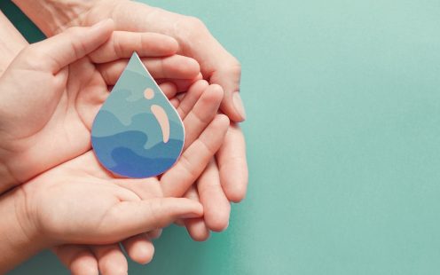 Adult and child hands holding paper cut water drop, World Water Day,  Clean water and sanitation, CSR, save water,  ecology concept  