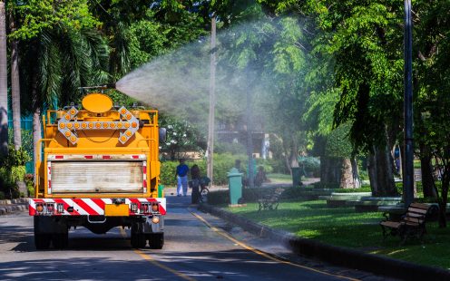 Watering in Public Park with Big Tank Sprayer showing Water mist Droplets